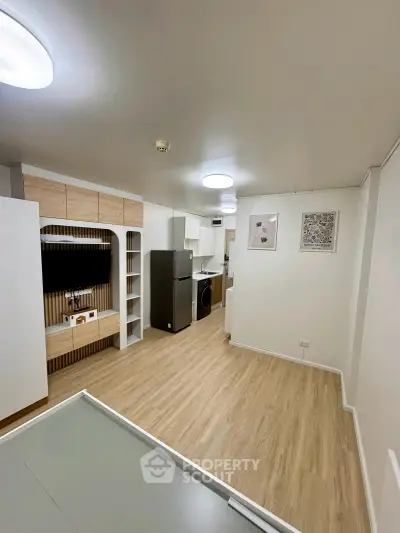 Modern open-plan living area with sleek kitchen and stylish storage solutions.