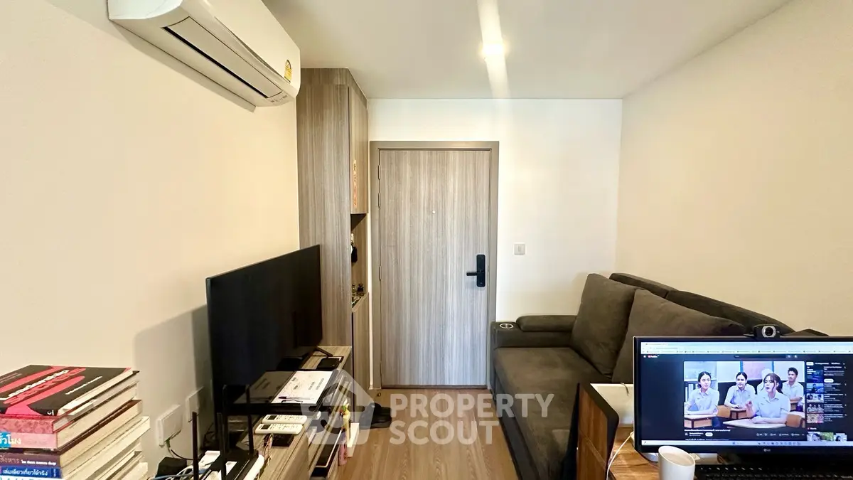 Modern living room with sleek furniture and air conditioning, perfect for cozy urban living.