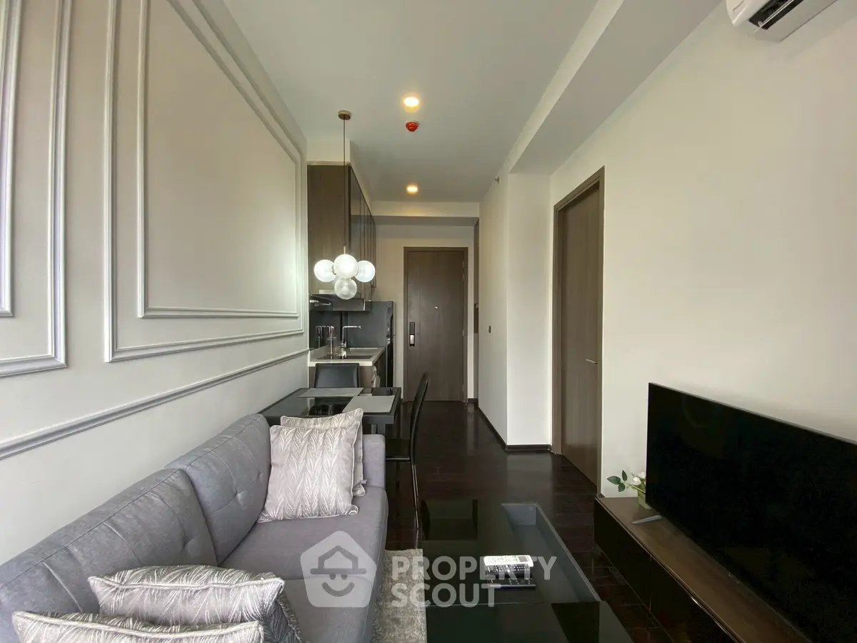 Modern living room with sleek design and open layout, featuring a stylish sofa and contemporary decor.