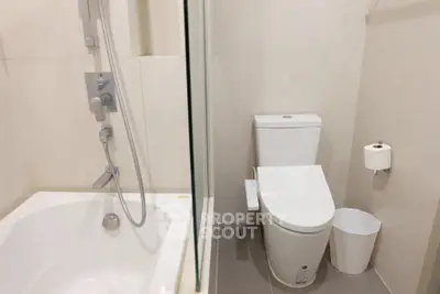 Modern bathroom with sleek fixtures and a bathtub in a contemporary apartment.