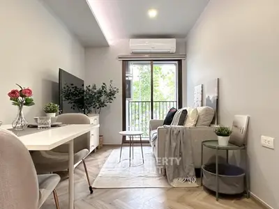 Modern living room with stylish decor and balcony view, perfect for urban living.
