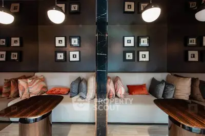 Stylish modern lounge area with elegant seating and artistic wall decor