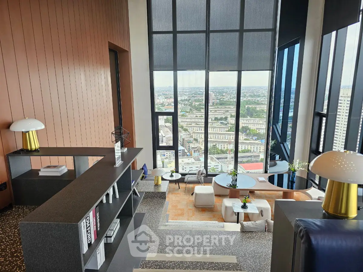 Luxurious high-rise living room with panoramic city view and modern decor.
