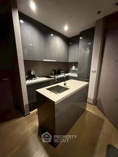 Modern kitchen with sleek cabinetry and island in contemporary apartment