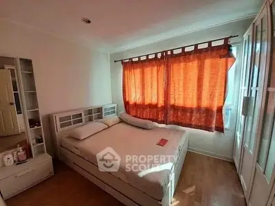Cozy bedroom with natural light and modern furnishings, perfect for relaxation.