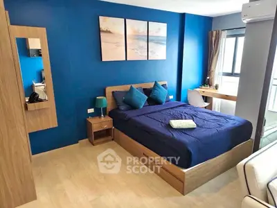 Modern bedroom with blue accent wall and stylish wooden furniture
