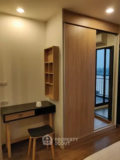 Modern bedroom with sliding closet doors and balcony access