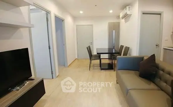 Modern living room with sleek furniture and open layout in a stylish apartment.