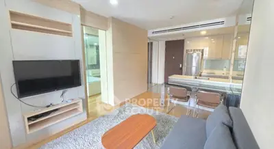 Modern living room with open kitchen and stylish decor in a cozy apartment.