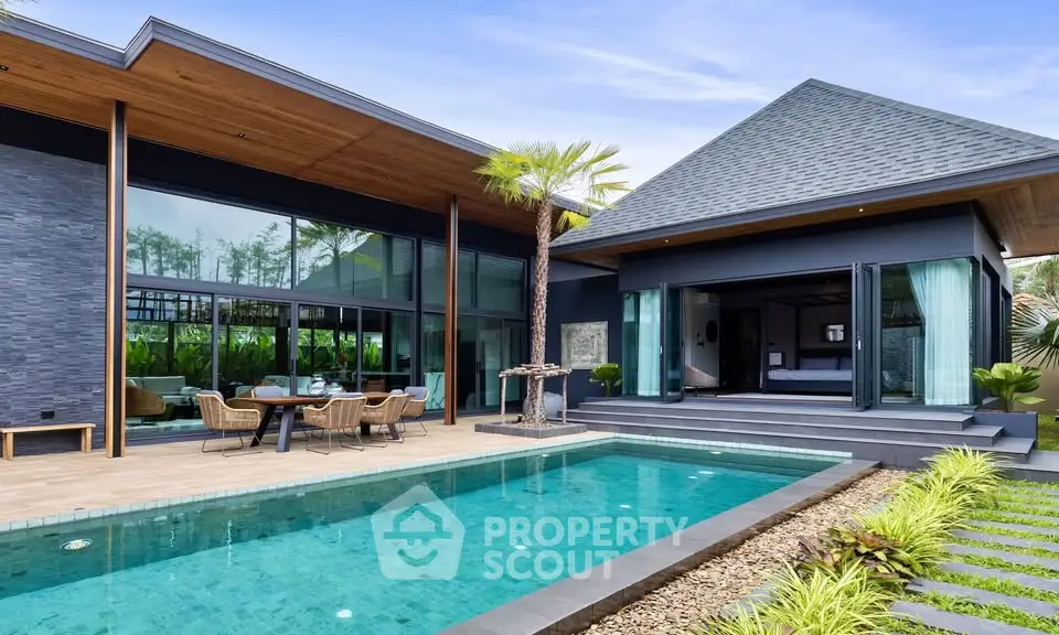 Luxurious modern villa with private pool and lush garden, featuring sleek architecture and spacious outdoor living area.