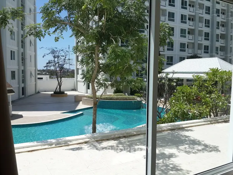 Luxurious apartment complex with stunning pool view and lush greenery