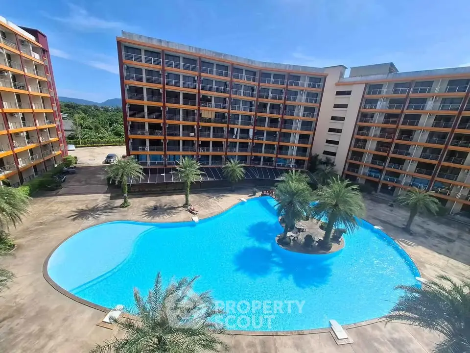 Stunning apartment complex with a large pool and palm trees, perfect for resort-style living.