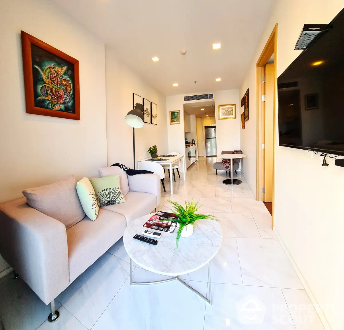 Bright and airy open-plan living space with modern furnishings, sleek white flooring, and tasteful art, perfect for urban living.