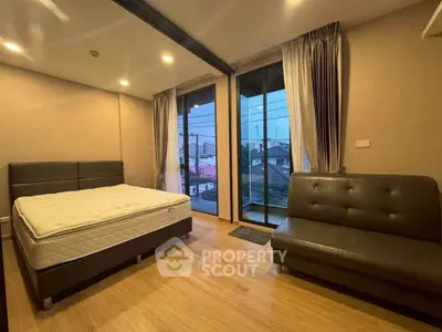 Spacious bedroom with modern furnishings and large windows offering a serene view, perfect for relaxation.