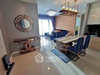 Luxurious living room with elegant decor and modern furniture, featuring a stylish chandelier and large windows.