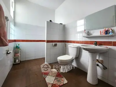 Spacious bathroom with modern fixtures and stylish tile accents