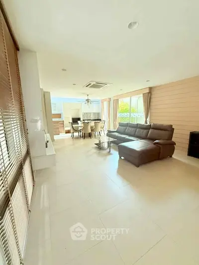 Spacious living room with modern furniture and open layout, perfect for family gatherings.