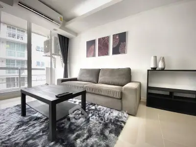 Modern living room with plush sofa and stylish decor in a high-rise apartment.