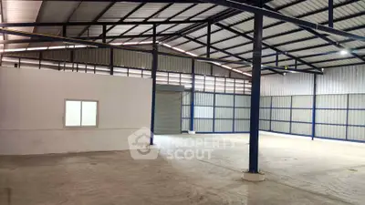 Spacious industrial warehouse with high ceilings and ample natural light.