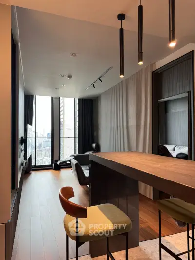 Modern living room with city view, sleek furniture, and stylish lighting in a high-rise apartment.