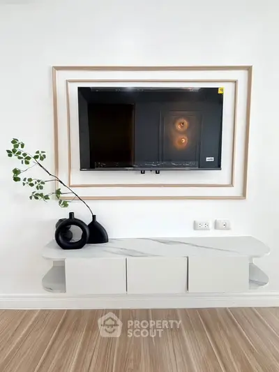 Modern living room with sleek wall-mounted TV and stylish decor