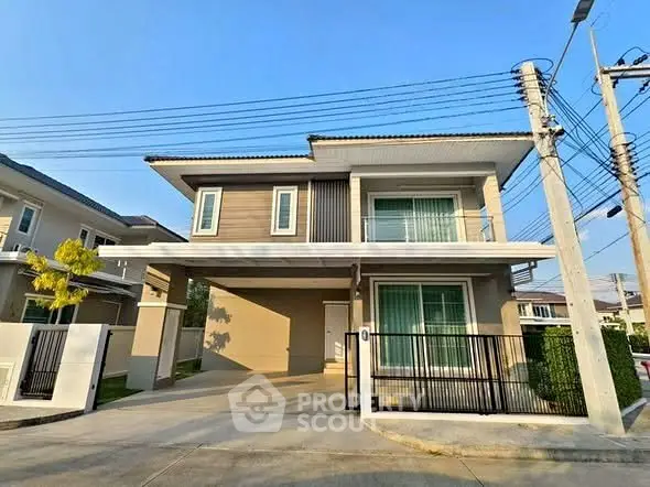 Modern two-story house with spacious driveway and contemporary design in a suburban neighborhood.