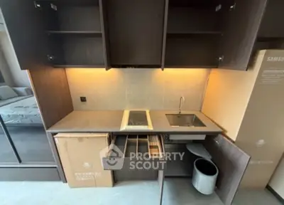 Modern kitchen with sleek cabinetry and built-in appliances in a compact layout.