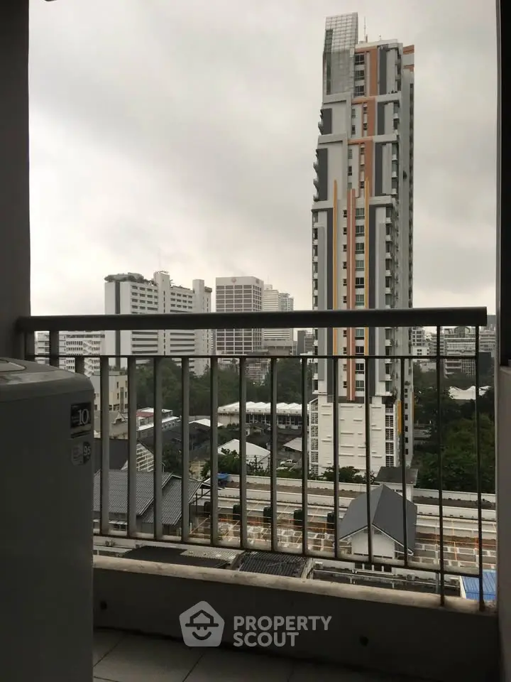 Stunning city view from a high-rise balcony with modern architecture.