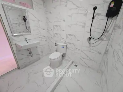 Modern bathroom with marble tiles and sleek fixtures