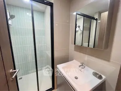 Modern bathroom with sleek shower and vanity in contemporary design.