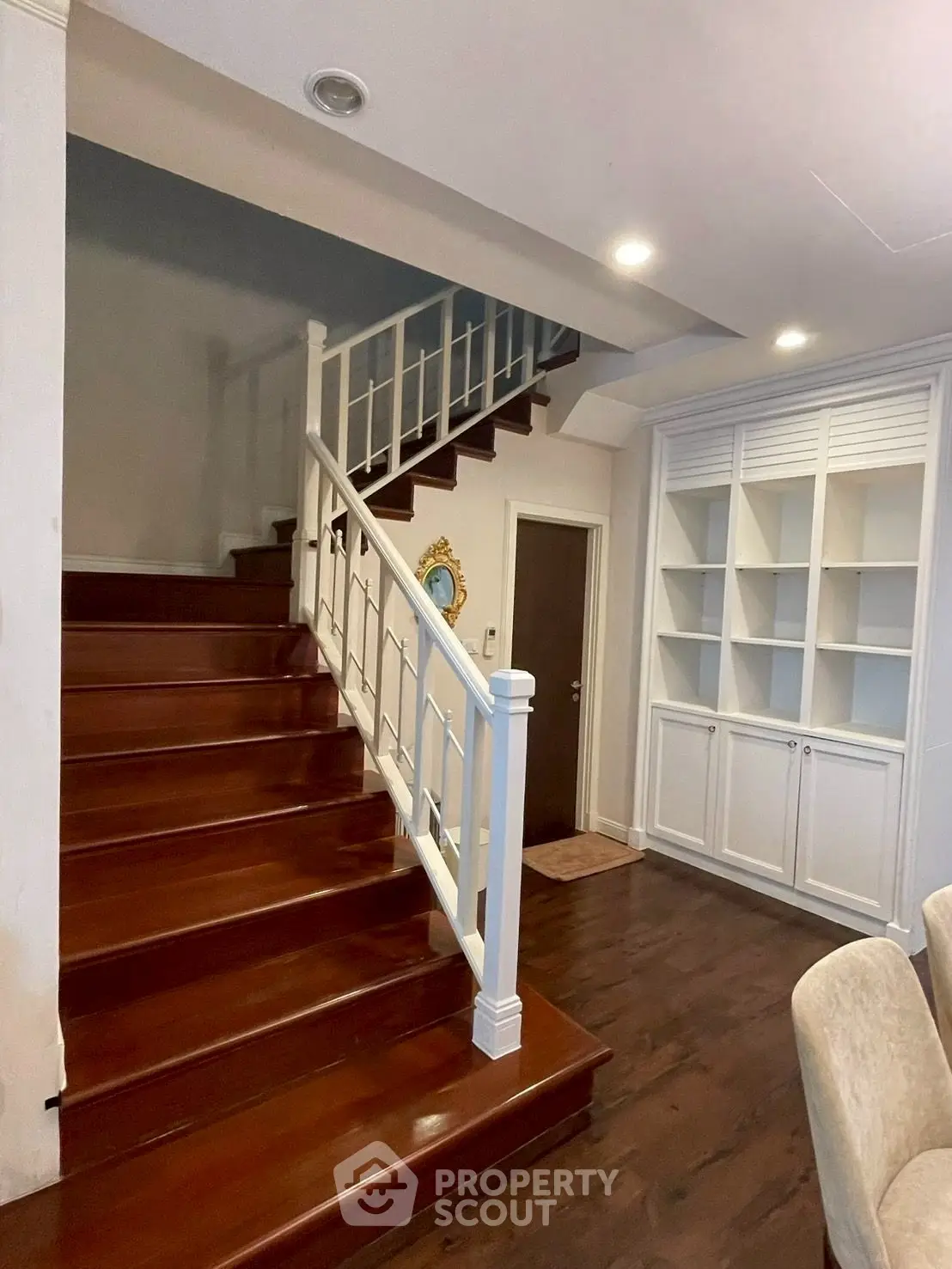Elegant staircase with wooden steps and built-in shelving in a modern home interior