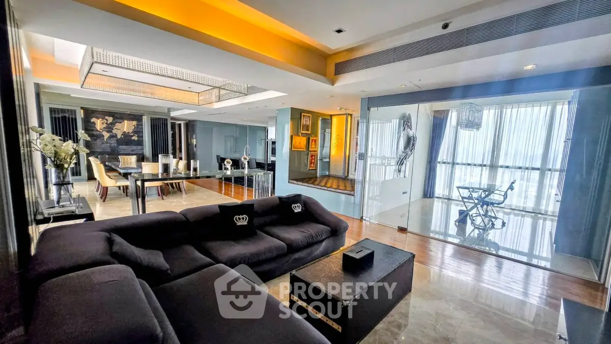 Luxurious modern living room with open layout and elegant dining area, featuring floor-to-ceiling windows and stylish decor.