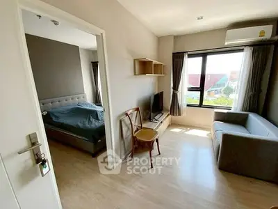 Modern apartment interior with cozy living room and bedroom, featuring natural light and stylish furnishings.
