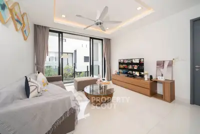 Modern living room with sleek design, large windows, and stylish furniture in a contemporary home.