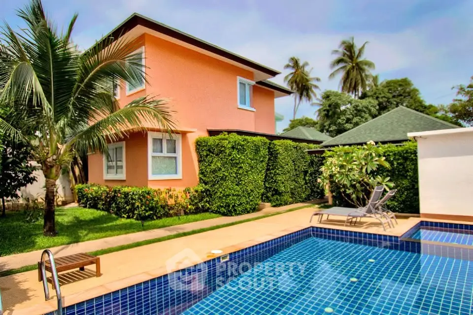 Charming villa with lush garden and inviting pool in tropical setting.