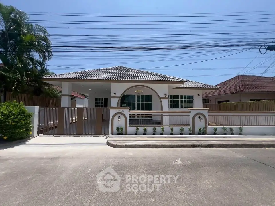 Charming single-story house with modern design and spacious driveway in a serene neighborhood.