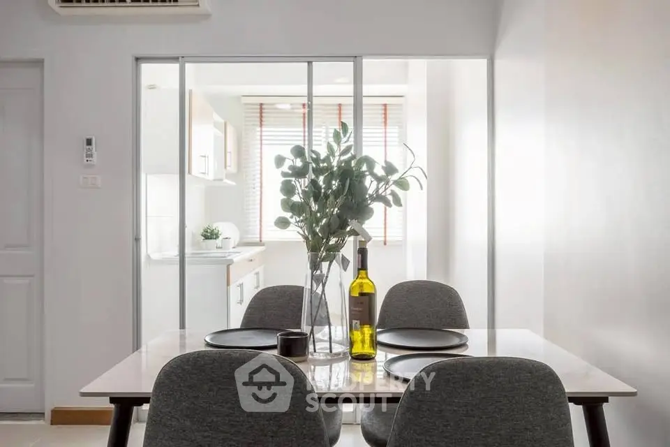 Modern dining area with elegant table setting and kitchen view