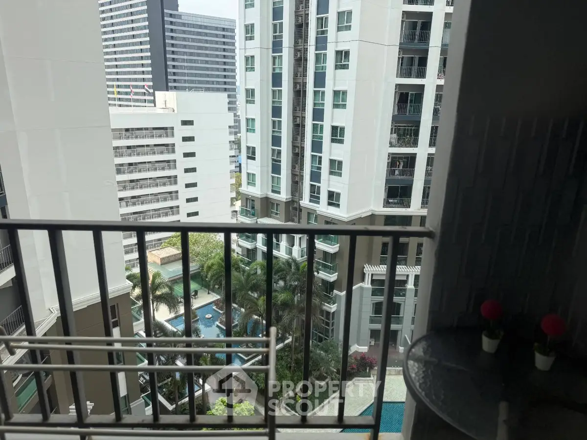 Stunning high-rise apartment view with pool and cityscape from balcony