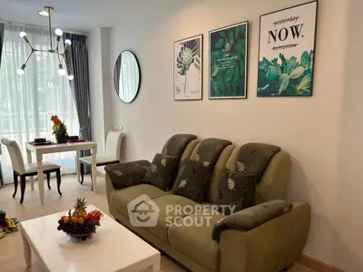 Stylish living room with modern decor and natural light, featuring a cozy sofa and elegant dining area.