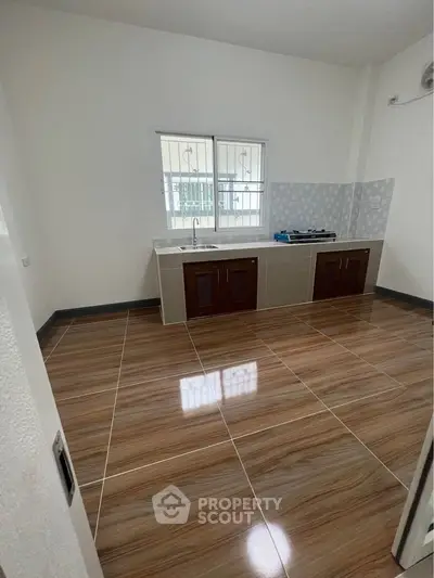 Modern kitchen with sleek tile flooring and built-in gas stove