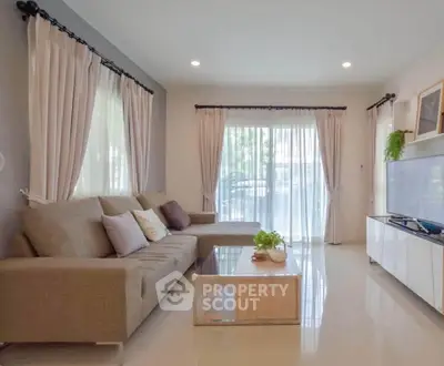 Spacious living room with modern decor and large windows for natural light.