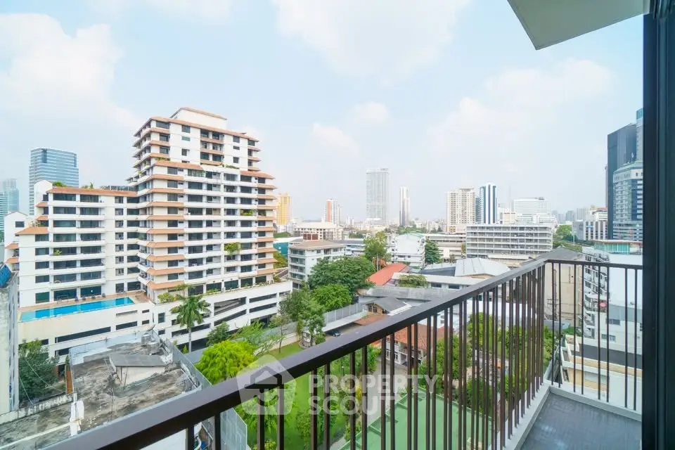 Stunning cityscape view from a modern balcony in a high-rise apartment.
