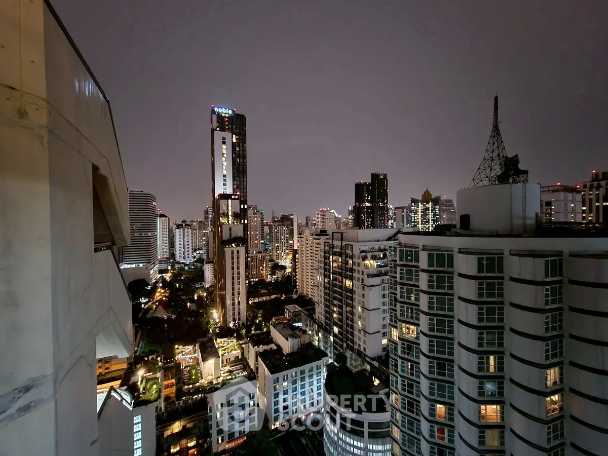 Stunning cityscape view from a high-rise building at night, showcasing vibrant urban living.