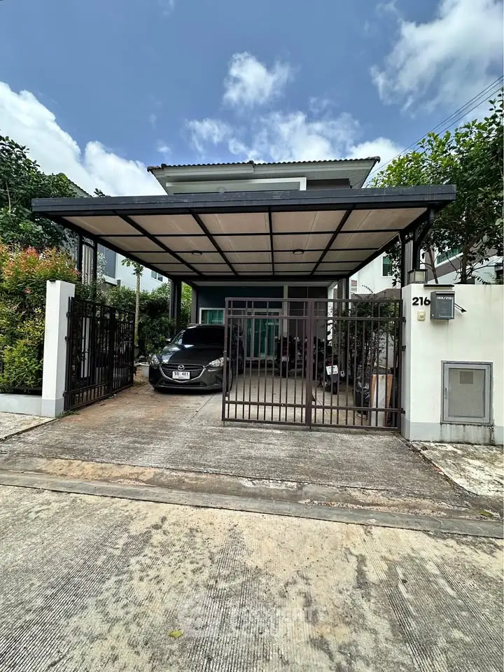 Modern two-story house with carport and sleek design in a suburban neighborhood.