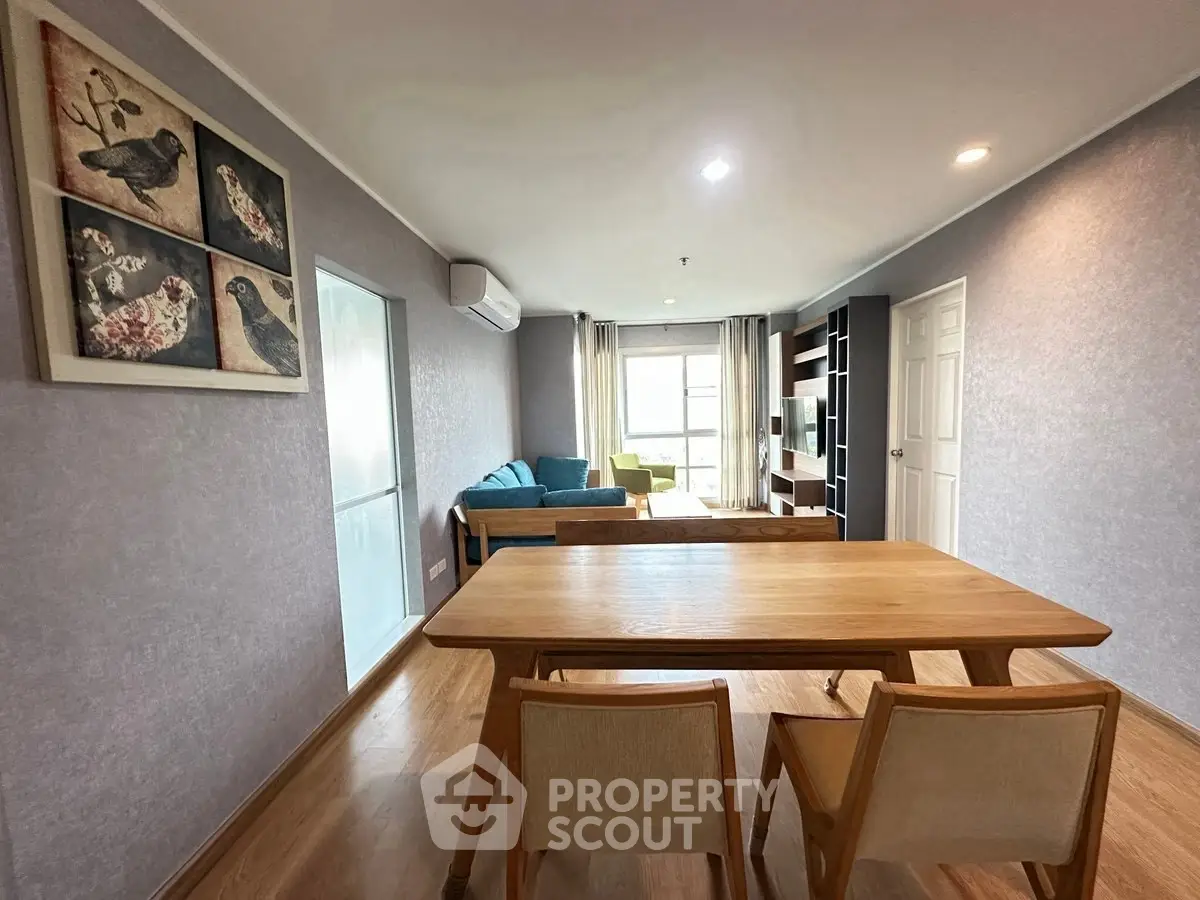 Spacious living room with modern decor and natural light in a stylish apartment.