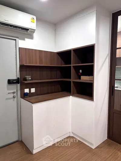 Modern storage unit with sleek design and wooden accents in a contemporary apartment.