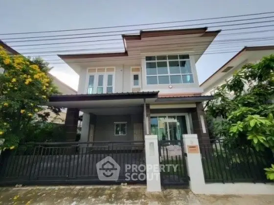 Modern two-story house with sleek design and spacious driveway in a serene neighborhood.