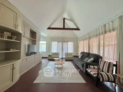Spacious living room with vaulted ceiling and elegant decor
