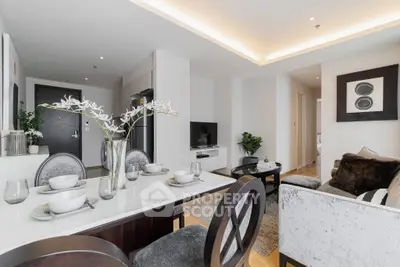 Modern living room with elegant dining area and stylish decor in a contemporary apartment.