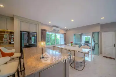 Spacious modern living room with elegant dining area and large windows for natural light.